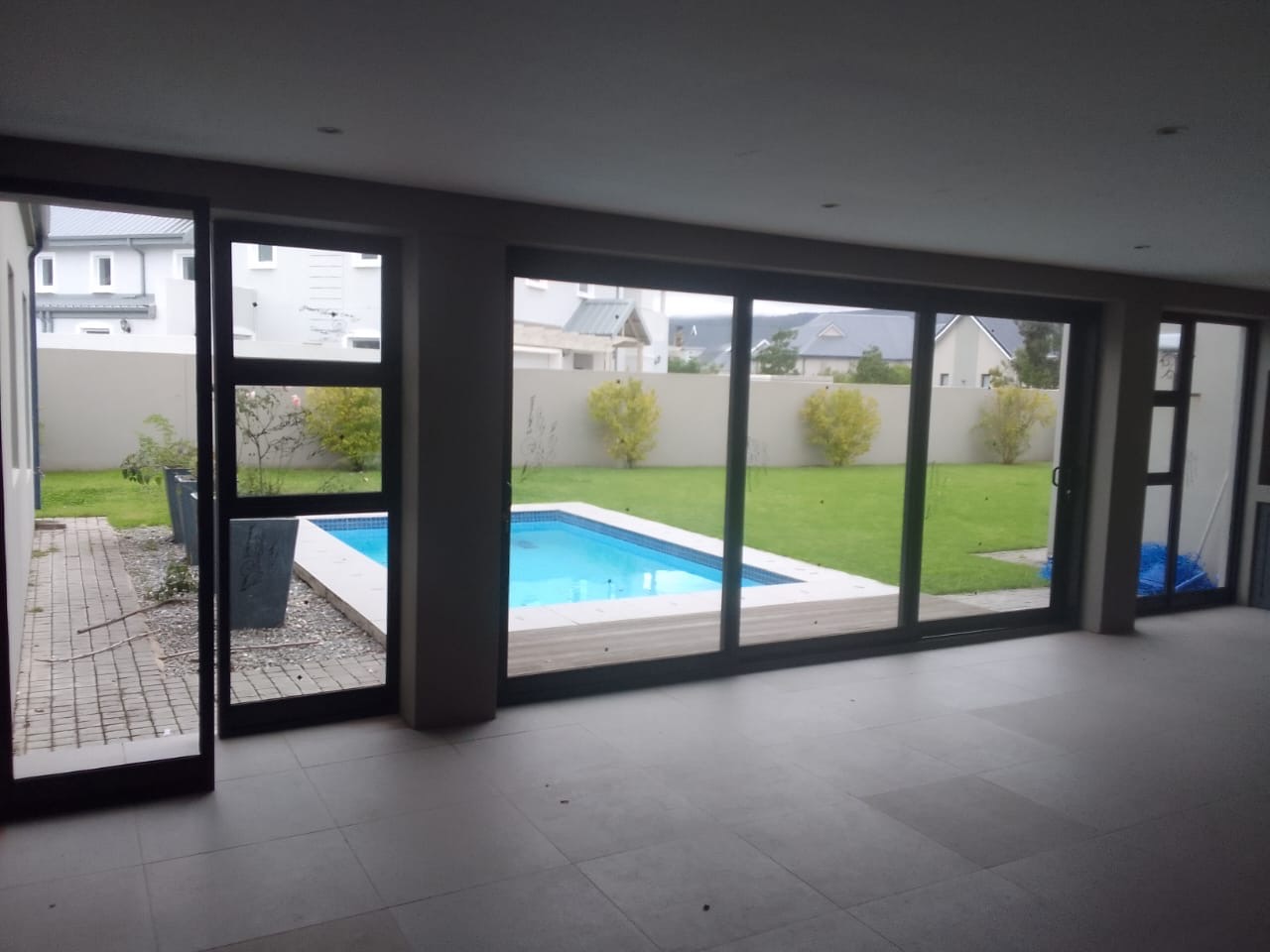 Open-plan living interior opening onto a landscaped pool area